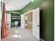 The well-lit office includes custom built-in shelving, modern lights, a comfortable office chair, and ample room to work at 1511 Fairway Dr, Charleston, SC 29412