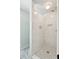 The tiled shower features mosaic flooring, tiled walls, and built-in shelving niches for toiletries and essentials at 1511 Fairway Dr, Charleston, SC 29412