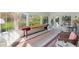 Bright sunroom with floor to ceiling windows, shuffleboard table and seating at 1511 Fairway Dr, Charleston, SC 29412