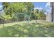 Large fenced backyard with a swing set, slide, and lush green grass at 1513 Cultivation Ln, Mount Pleasant, SC 29466