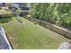 Large fenced backyard with a swing set, slide, and lush green grass at 1513 Cultivation Ln, Mount Pleasant, SC 29466