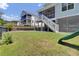 Backyard featuring a swing set, stairs to the home, and lush green grass at 1513 Cultivation Ln, Mount Pleasant, SC 29466