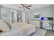 Spacious bedroom with a decorative ceiling fan, television, and well-organized office setup at 1513 Cultivation Ln, Mount Pleasant, SC 29466