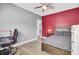 Bedroom featuring sleek ceiling fan, wood floors, neutral gray walls and red accent wall at 1513 Cultivation Ln, Mount Pleasant, SC 29466