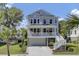 Charming two-story home with a front porch, white railings, and well-manicured landscaping at 1513 Cultivation Ln, Mount Pleasant, SC 29466