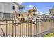 A community playground features a wooden playset and is bordered by a black metal fence for safety at 1513 Cultivation Ln, Mount Pleasant, SC 29466