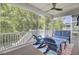 Screened porch with wood ceiling fan, seating, and green tree views at 1513 Cultivation Ln, Mount Pleasant, SC 29466