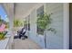 Inviting porch with outdoor seating, white columns, and a glimpse of the surrounding scenery at 1513 Cultivation Ln, Mount Pleasant, SC 29466