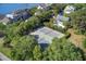 Aerial view of the community tennis courts surrounded by trees, with homes and a waterway in the background at 1551 Ben Sawyer Blvd # 44, Mount Pleasant, SC 29464