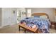 Well lit bedroom featuring a wicker bed frame, carpeted floors, and access to an ensuite bathroom at 1551 Ben Sawyer Blvd # 44, Mount Pleasant, SC 29464