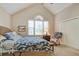 Vaulted ceiling bedroom featuring a wicker bed frame, large windows and carpeted floors at 1551 Ben Sawyer Blvd # 44, Mount Pleasant, SC 29464