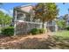 Picturesque home featuring a screened porch surrounded by mature trees, providing a private outdoor retreat at 1551 Ben Sawyer Blvd # 44, Mount Pleasant, SC 29464