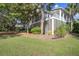 Charming home with a screened porch, lush greenery, and mature trees, offering a serene outdoor living space at 1551 Ben Sawyer Blvd # 44, Mount Pleasant, SC 29464