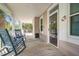 Inviting front porch with rocking chairs, providing a relaxing outdoor space with charming details at 1551 Ben Sawyer Blvd # 44, Mount Pleasant, SC 29464