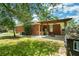 Charming brick home with a covered patio, vibrant lawn, and a delightful playset for outdoor fun at 1915 Aichele Dr, North Charleston, SC 29406