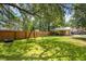 Expansive backyard with a swing set, storage building, and a wooden fence ensuring privacy at 1915 Aichele Dr, North Charleston, SC 29406