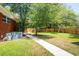 A lush backyard featuring a well-maintained lawn, trees, and playset perfect for outdoor activities and relaxation at 1915 Aichele Dr, North Charleston, SC 29406
