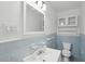Traditional bathroom with blue tile accents, vanity, and storage cabinet at 1915 Aichele Dr, North Charleston, SC 29406