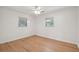 Bedroom featuring hardwood floors, white walls, and natural light from two windows at 1915 Aichele Dr, North Charleston, SC 29406