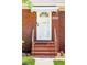 Close-up of the brick home's front door, featuring a white awning and decorative details at 1915 Aichele Dr, North Charleston, SC 29406