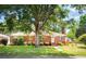 Charming brick home with a well-manicured lawn and mature shade tree in a desirable neighborhood at 1915 Aichele Dr, North Charleston, SC 29406