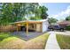 Exterior of the outbuilding garage and carport alongside a well-maintained yard, providing additional covered parking at 1915 Aichele Dr, North Charleston, SC 29406