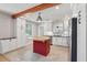 Bright kitchen features white cabinets, stainless steel appliances, an island with butcher block top, and a decorative wood beam at 1915 Aichele Dr, North Charleston, SC 29406