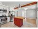 Bright kitchen features white cabinets, stainless steel appliances, an island with butcher block top, and a decorative wood beam at 1915 Aichele Dr, North Charleston, SC 29406