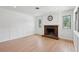 Spacious living room with a brick fireplace, white walls, and hardwood floors at 1915 Aichele Dr, North Charleston, SC 29406