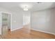 An empty light-filled living room offers pristine hardwood floors and crisp neutral paint, creating a versatile and inviting space at 1915 Aichele Dr, North Charleston, SC 29406