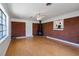 Living room featuring a wood-burning stove, brick accent wall, and cork flooring at 1915 Aichele Dr, North Charleston, SC 29406