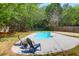 Backyard featuring a private kidney-shaped pool, surrounded by a patio, and mature trees at 1918 Armory Dr, Mount Pleasant, SC 29466
