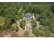 Expansive property showcasing a grand home, manicured gardens, pool, and private wooded acreage at 1972 Long Creek Rd, Wadmalaw Island, SC 29487
