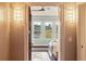Cozy bedroom with a lakeside view through a window and decorative sconces at 1972 Long Creek Rd, Wadmalaw Island, SC 29487