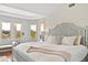 Bright bedroom featuring a large bed, bay windows, and tranquil views of the natural surroundings at 1972 Long Creek Rd, Wadmalaw Island, SC 29487