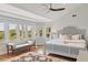 Comfortable bedroom featuring hardwood floors, a bay window with an exterior view, and a decorative ceiling fan at 1972 Long Creek Rd, Wadmalaw Island, SC 29487