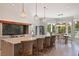 Well-appointed kitchen with a large island, bar stools, and adjacent dining area with water views at 1972 Long Creek Rd, Wadmalaw Island, SC 29487