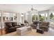 Spacious living room with large windows offering natural light and views of the outdoor scenery at 1972 Long Creek Rd, Wadmalaw Island, SC 29487