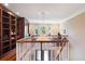 Bright, airy living room featuring a stunning chandelier and elegant staircase at 1972 Long Creek Rd, Wadmalaw Island, SC 29487