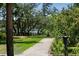 Scenic garden path leading to the water, framed by beautiful landscaping and mature trees at 1972 Long Creek Rd, Wadmalaw Island, SC 29487