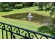 Scenic view of a pond with a fountain, surrounded by lush greenery, offering a tranquil retreat at 1972 Long Creek Rd, Wadmalaw Island, SC 29487