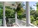 Cozy porch with rocking chair and decorative hanging flower basket at 1972 Long Creek Rd, Wadmalaw Island, SC 29487