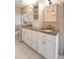 Bright bathroom featuring double vanity, granite countertops, and custom white cabinets for ample storage at 2 Pierates Cruz, Mount Pleasant, SC 29464