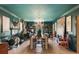 Elegant dining room featuring a fireplace, chandelier, extensive built-in bookshelves, and hardwood floors at 2 Pierates Cruz, Mount Pleasant, SC 29464