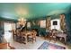 An elegant dining room with a fireplace, chandelier, and desk, creating a versatile living space at 2 Pierates Cruz, Mount Pleasant, SC 29464