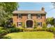 Beautiful two-story brick home with manicured lawn, featuring black shutters and an American flag at 2 Pierates Cruz, Mount Pleasant, SC 29464