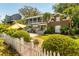 Charming home featuring a white picket fence and lush landscaping, creating a welcoming curb appeal at 2 Pierates Cruz, Mount Pleasant, SC 29464