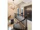 Elegant hallway with dark accents, a chandelier, and access to the rooms upstairs at 2 Pierates Cruz, Mount Pleasant, SC 29464