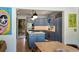 Open kitchen with blue cabinets, stainless appliances, and eat-in dining area at 2 Pierates Cruz, Mount Pleasant, SC 29464
