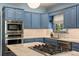Well-equipped kitchen features stainless steel appliances, blue cabinets and marble countertops at 2 Pierates Cruz, Mount Pleasant, SC 29464